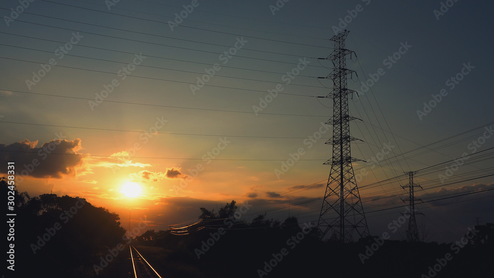 Pictures of electrical transportation through high voltage poles during sunrise time. Electric power transportation concept