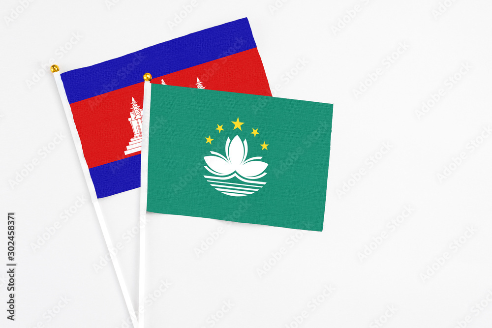 Macao and Cambodia stick flags on white background. High quality fabric, miniature national flag. Peaceful global concept.White floor for copy space. Macao and Cambodia stick flags on white background. High quality fabric, miniature national flag. Peaceful global concept.White floor for copy space.