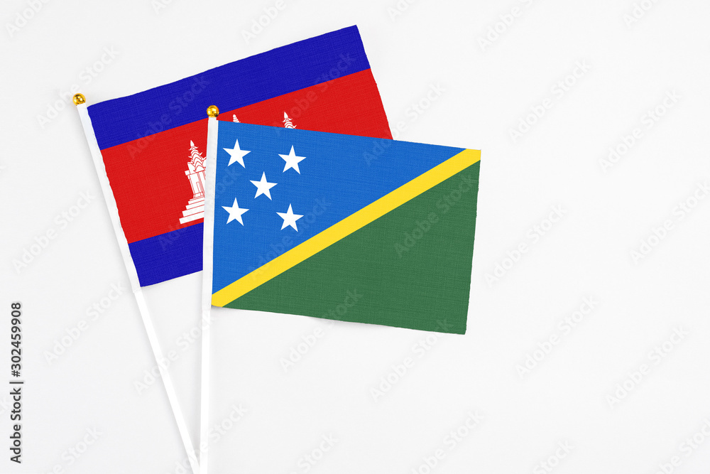 Solomon Islands and Cambodia stick flags on white background. High quality fabric, miniature national flag. Peaceful global concept.White floor for copy space. Solomon Islands and Cambodia stick flags on white background. High quality fabric, miniature national flag. Peaceful global concept.White floor for copy space.