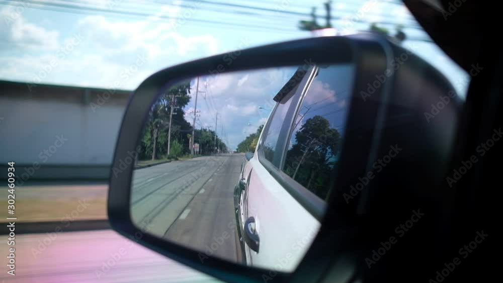 Cars are running on the road. Side view mirror Cars are running on the road. Side view mirror