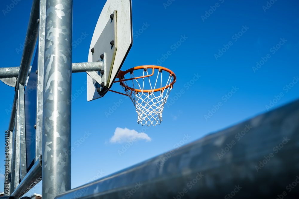 Basketball hoop on a background of blue sky.