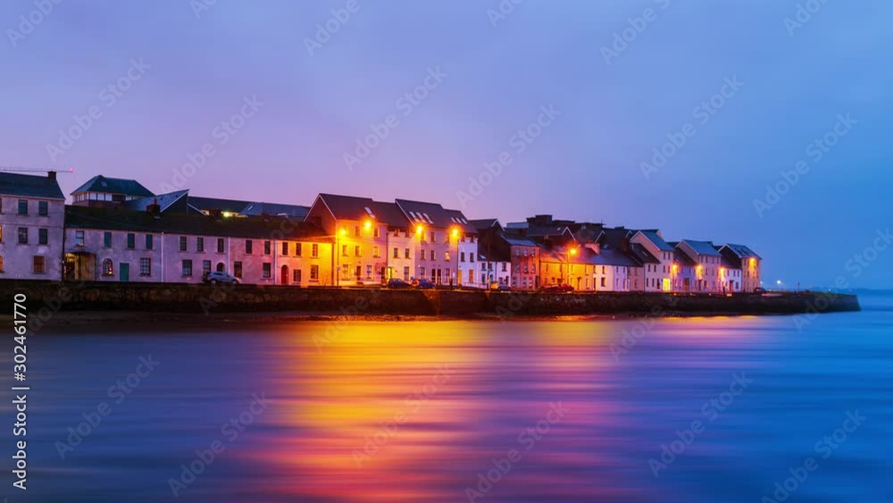 Galway, Ireland. Beautiful landscape of Galway, Ireland. River and famous painted houses with cloudy colorful sky. Time-lapse during the sunrise, zoom in Galway, Ireland. Beautiful landscape of Galway, Ireland. River and famous painted houses with cloudy colorful sky. Time-lapse during the sunrise, zoom in
