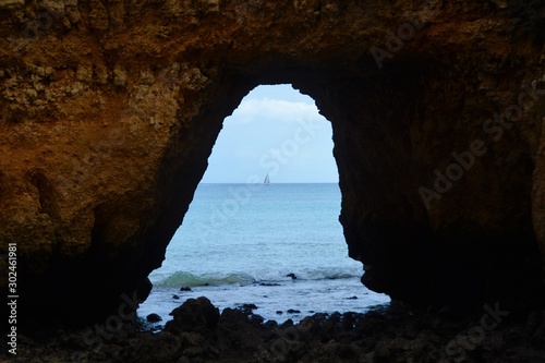 the ocean seen through a hole in the rock