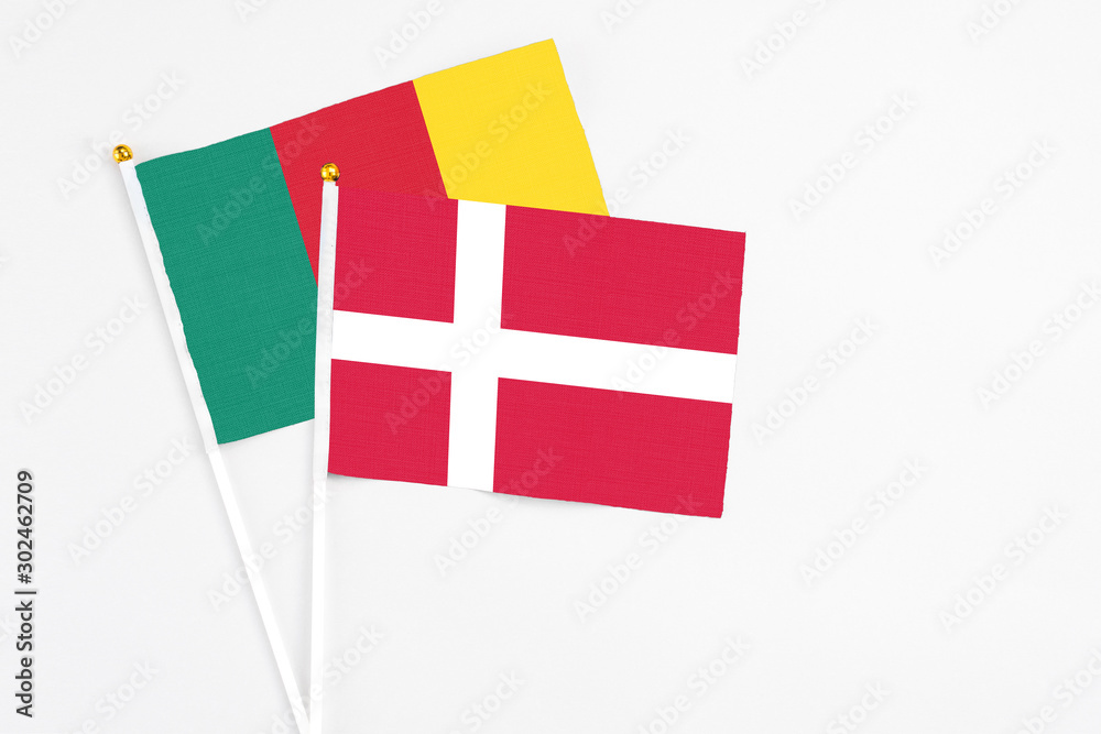 Denmark and Cameroon stick flags on white background. High quality fabric, miniature national flag. Peaceful global concept.White floor for copy space.