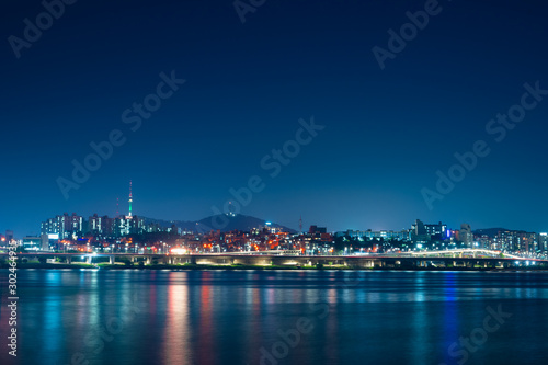 night and city scape travel and photography activity from banpo bridge is beautiful  architecture and design during show fountain moving to people and traveler with reflection in river background © tickcharoen04