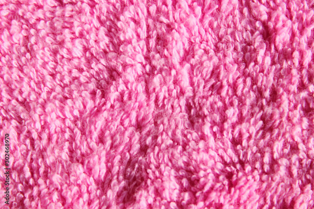 Blurred image of a pink fabric texture. Abstract textile background. Pink color background, space for text. Blurred image of a pink fabric texture. Abstract textile background. Pink color background, space for text.