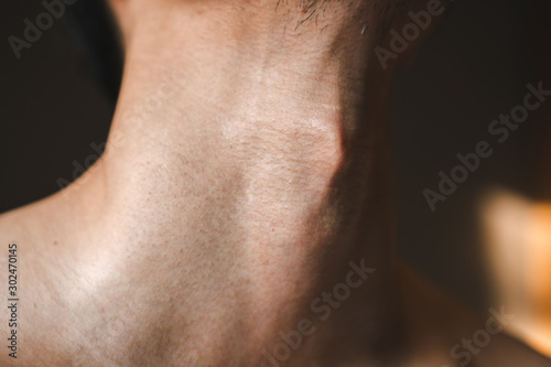 Man's neck with Adam's apple a part of body men humen anatomy close up shot.