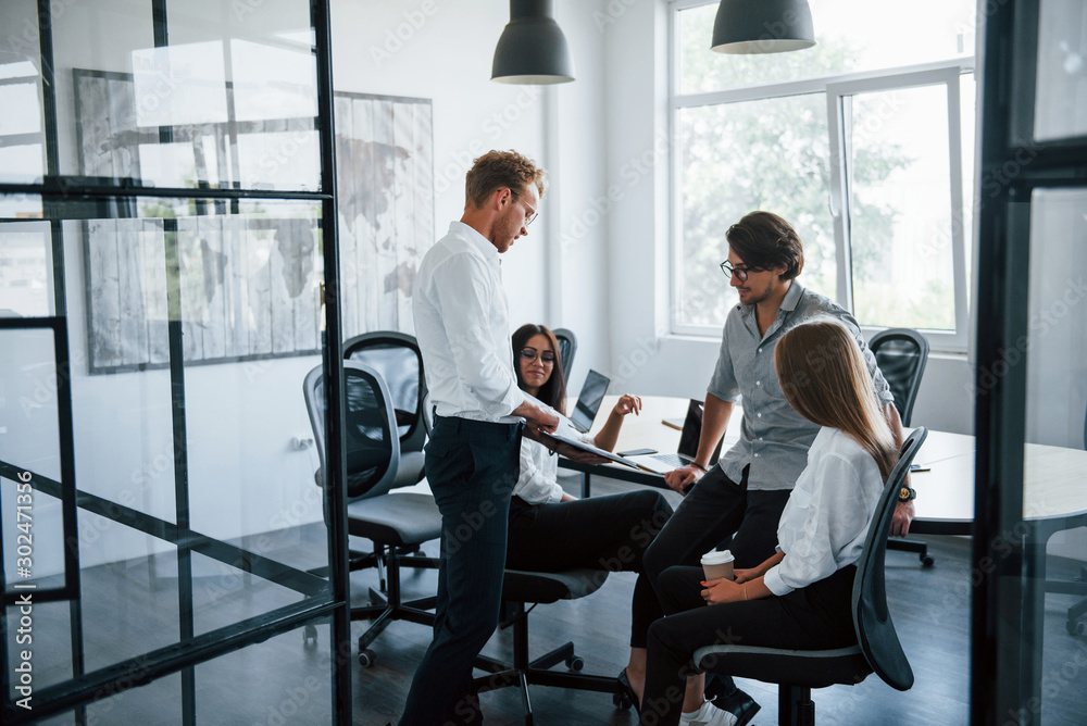 Active conversation. Young business people in formal clothes working in the office