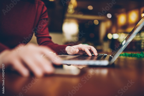 Selective focus on woman's hand keyboarding search query in browser while looking for information in network on laptop connected to internet.Cropped blurred image of female person using gadget
