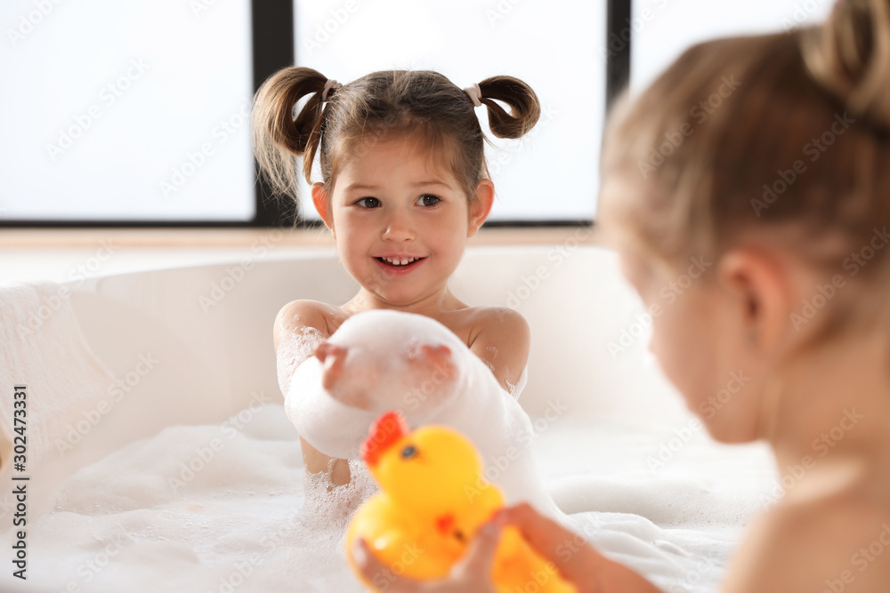 Cute little sisters taking bubble bath together Stock Photo Adobe Stock