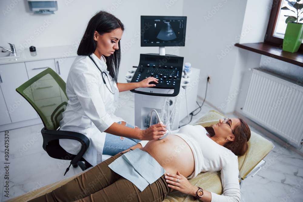 Female doctor does ultrasound for a pregnant woman in the hospital Female doctor does ultrasound for a pregnant woman in the hospital