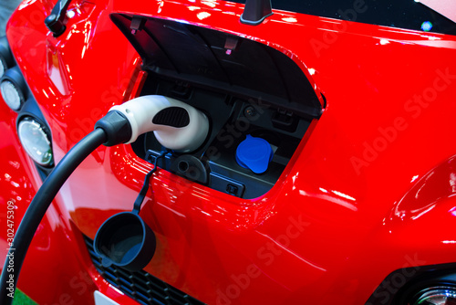Red electric car at charging in station © 25krunya