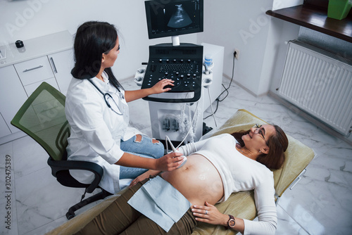 Female doctor does ultrasound for a pregnant woman in the hospital