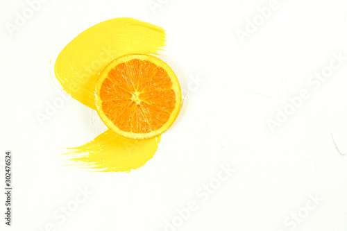 Sliced orange and orange juice spreading on a white background - clipping path