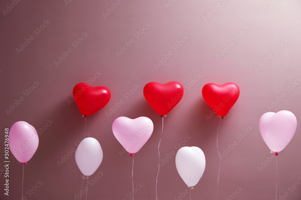 Colorful heart shaped balloons on brown background. Valentine's day celebration