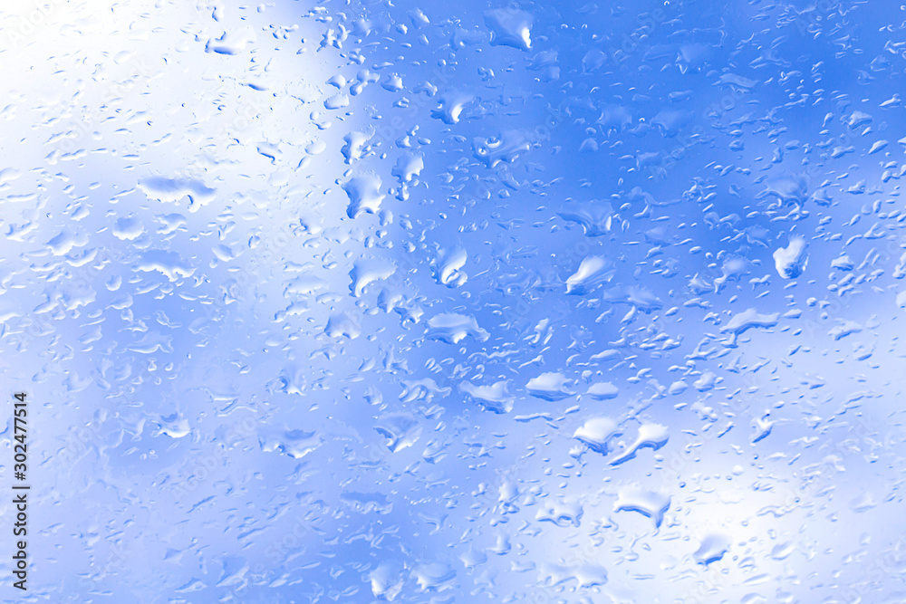 drops of rain on glass window blurred forest background drops of rain on glass window blurred forest background