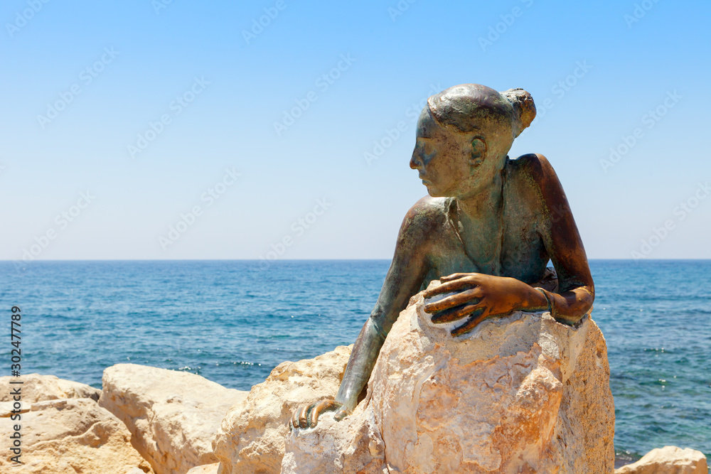 PAPHOS, CYPRUS July 24, 2019 "Sol Alter", Bronze statue of the young