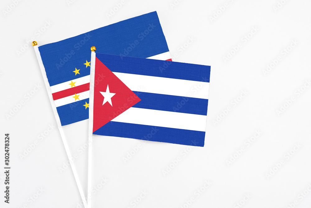 Obraz premium Cuba and Cape Verde stick flags on white background. High quality fabric, miniature national flag. Peaceful global concept.White floor for copy space.