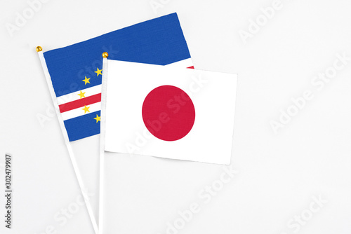 Japan and Cape Verde stick flags on white background. High quality fabric, miniature national flag. Peaceful global concept.White floor for copy space. Free Download Japan and Cape Verde stick flags on white background. High quality fabric, miniature national flag. Peaceful global concept.White floor for copy space. - GFXLoad