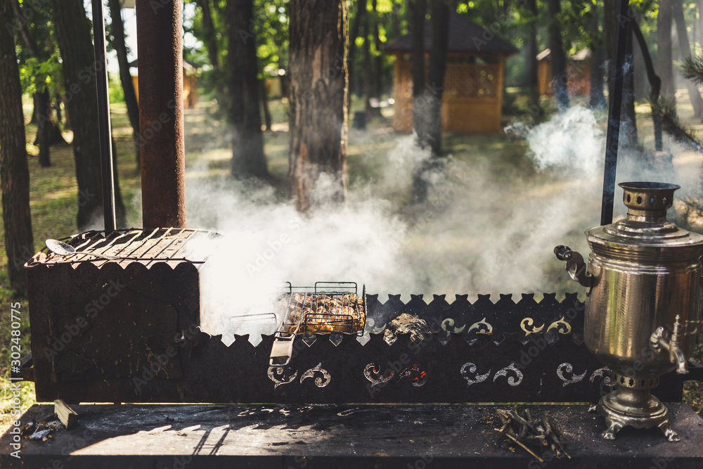 Barbecue with a samovar and grilled meat in nature Barbecue with a samovar and grilled meat in nature