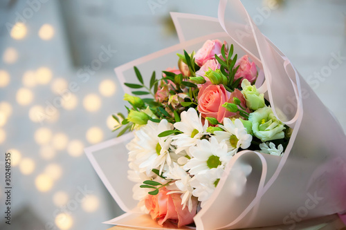 Bouquet of flowers on a bokeh background. Floristics Luxurious flowers for a gift.