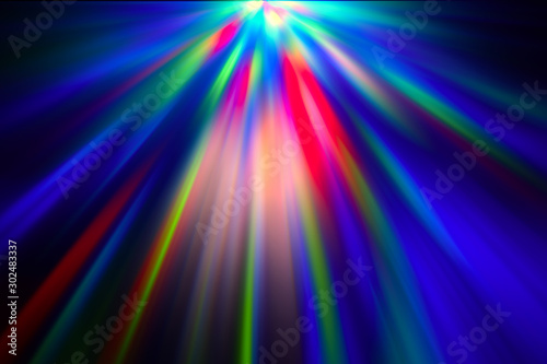 Multicolored rays of light shine through the facets of the crystal