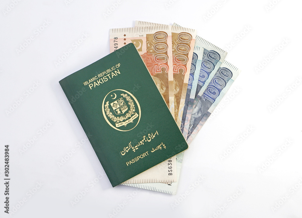 Pakistani Green Passport with one and five thousand rupees currency notes Pakistani Green Passport with one and five thousand rupees currency notes