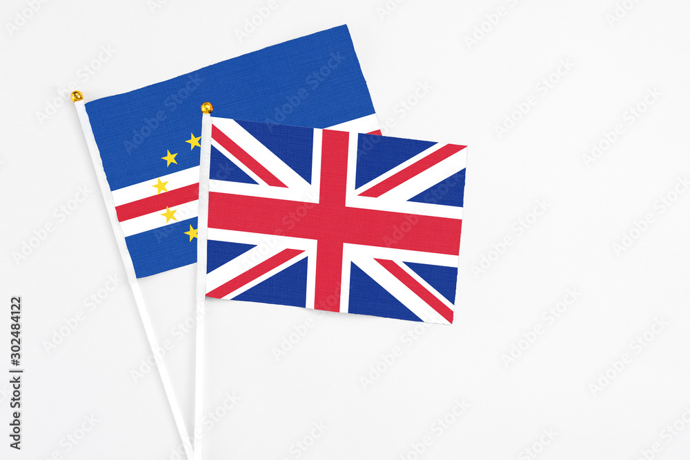 United Kingdom and Cape Verde stick flags on white background. High quality fabric, miniature national flag. Peaceful global concept.White floor for copy space. United Kingdom and Cape Verde stick flags on white background. High quality fabric, miniature national flag. Peaceful global concept.White floor for copy space.