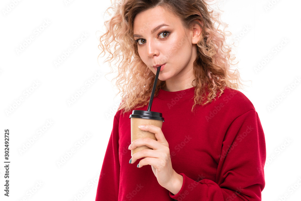 Caucasian girl with curly fair hair drinks coffe and smiles, portrait isolated on white background Caucasian girl with curly fair hair drinks coffe and smiles, portrait isolated on white background