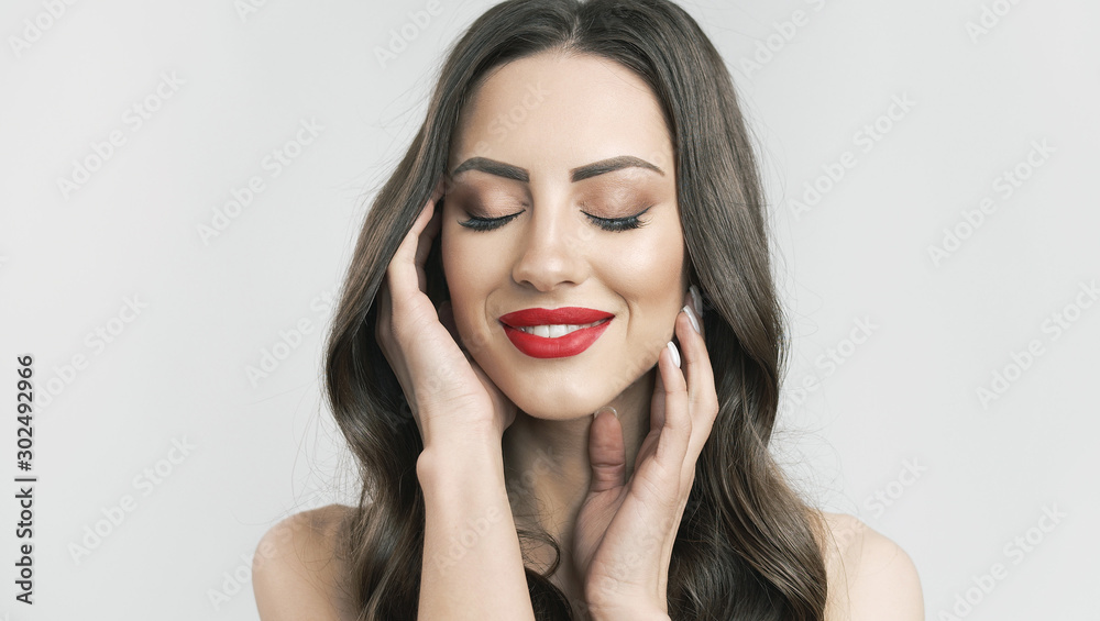 Portrait of beautiful brunette enjoying her soft skin with eyes closed isolated white background Portrait of beautiful brunette enjoying her soft skin with eyes closed isolated white background