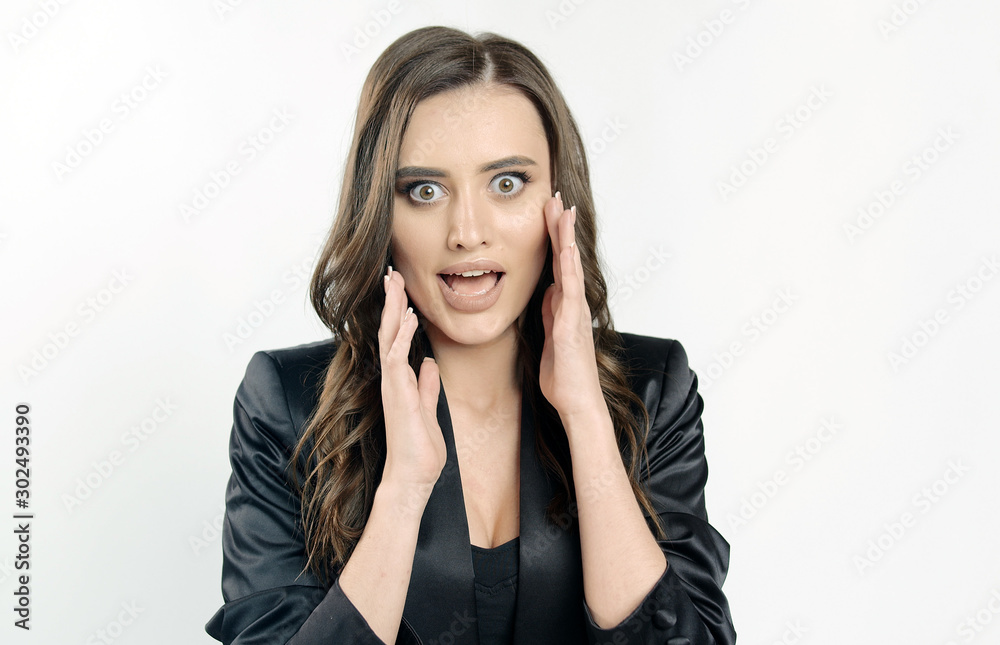 Real surprise emotions shown by a young cute woman in black official clothes isolated white background Real surprise emotions shown by a young cute woman in black official clothes isolated white background