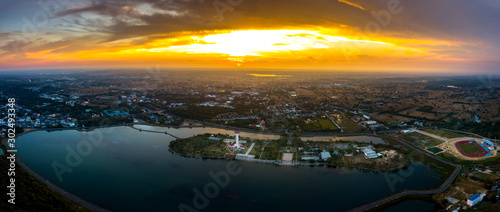 Amazing Top view Aerial photo sunrise in morning from flying drone over Chalermprakiat Tower at Koh Klang nam public park in Sisaket Thailand.