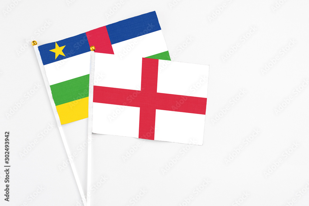 England and Central African Republic stick flags on white background. High quality fabric, miniature national flag. Peaceful global concept.White floor for copy space.