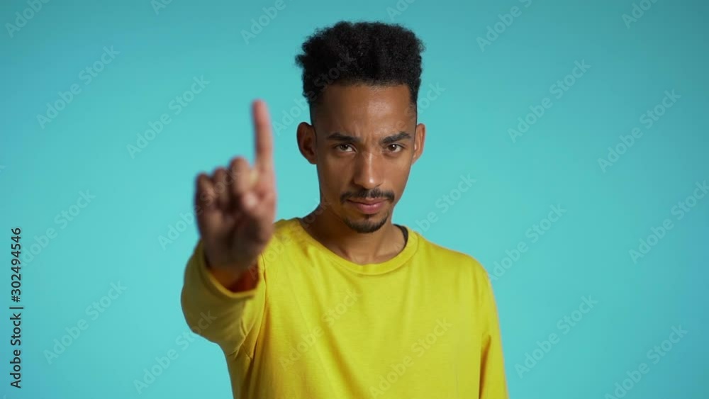 Denying, Rejecting, Disagree, Portrait of handsome guy. African american man disapproving with no hand sign make negation finger gesture. Slow motion. Denying, Rejecting, Disagree, Portrait of handsome guy. African american man disapproving with no hand sign make negation finger gesture. Slow motion.