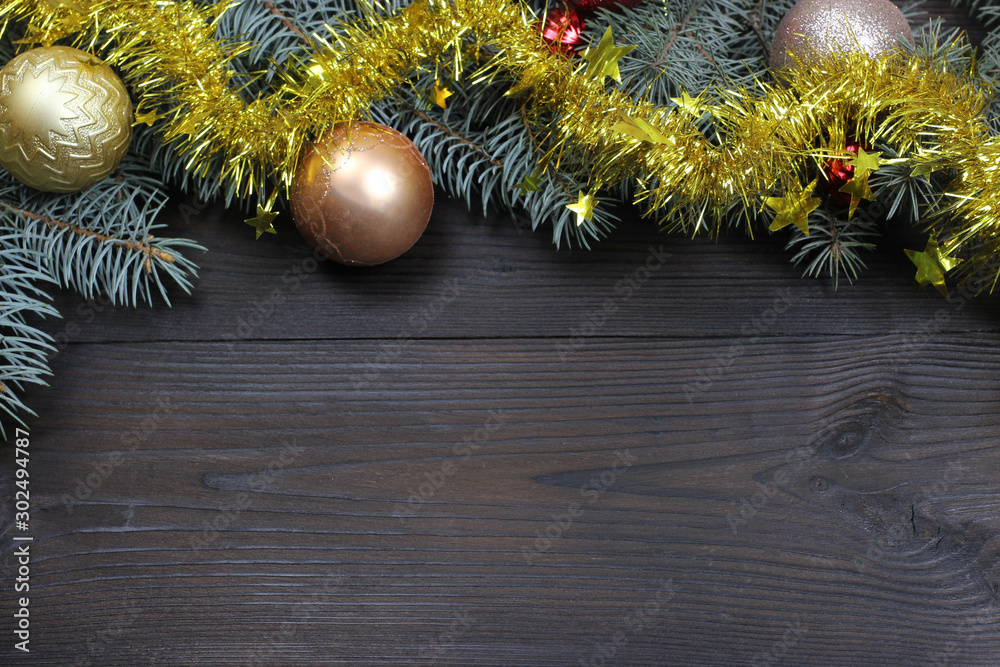 Fototapeta premium Christmas background. Christmas toys-balls on the Christmas tree, wooden background. The view from the top. Copy space