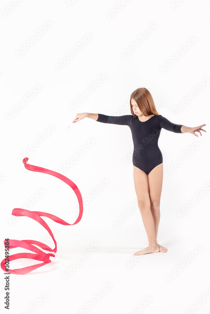 girl gymnast trains with a gymnastics tape on white background. children's professional sports.
