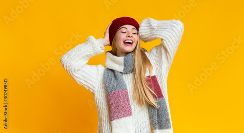 Slika na platnu Carefree girl in colorful knitted winter set enjoying her life