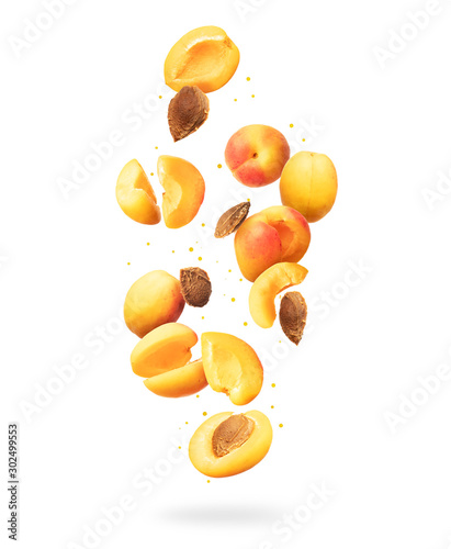 Foto Fresh whole and sliced fresh apricots in the air on a white background