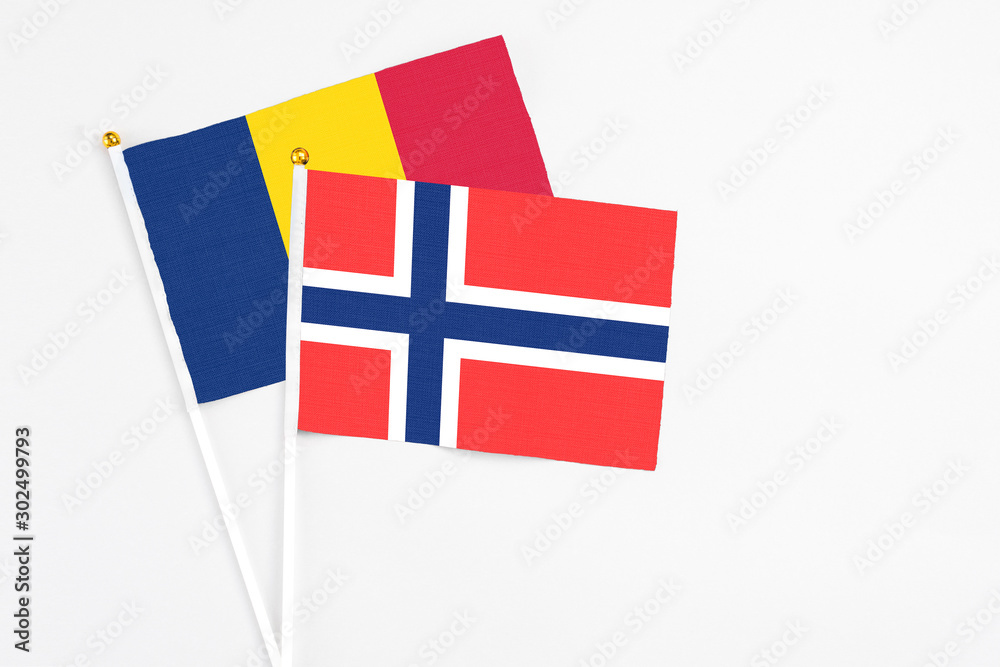 Bouvet Islands and Chad stick flags on white background. High quality fabric, miniature national flag. Peaceful global concept.White floor for copy space.