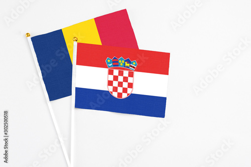 Croatia and Chad stick flags on white background. High quality fabric, miniature national flag. Peaceful global concept.White floor for copy space. photo