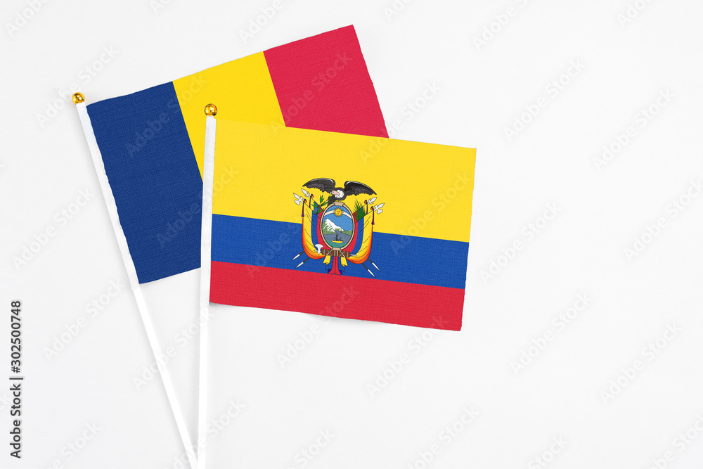 Fototapeta premium Ecuador and Chad stick flags on white background. High quality fabric, miniature national flag. Peaceful global concept.White floor for copy space.