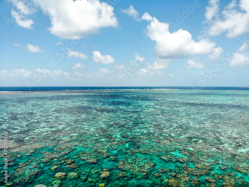 Low aerial over Norman Reef looking toward the horizon in the GBR  Australia