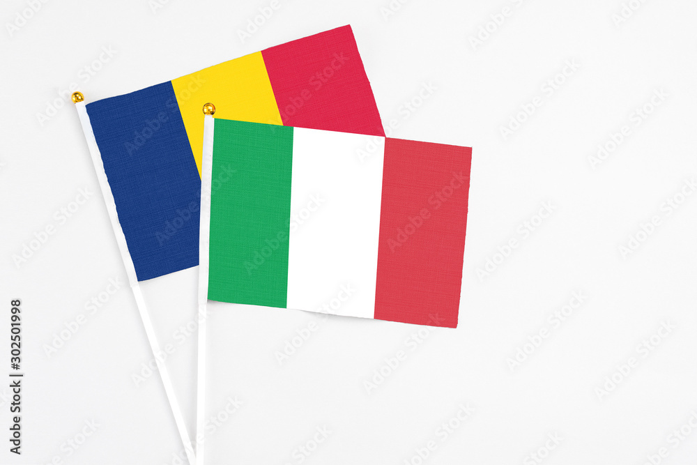 Italy and Chad stick flags on white background. High quality fabric, miniature national flag. Peaceful global concept.White floor for copy space. Italy and Chad stick flags on white background. High quality fabric, miniature national flag. Peaceful global concept.White floor for copy space.