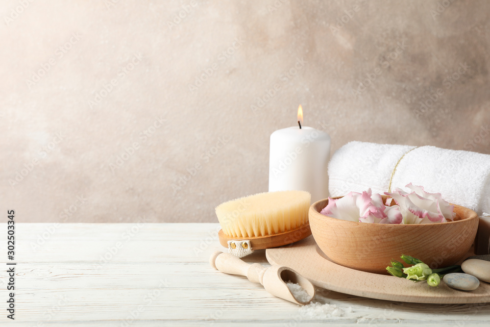 Spa accessories on white wooden background, space for text