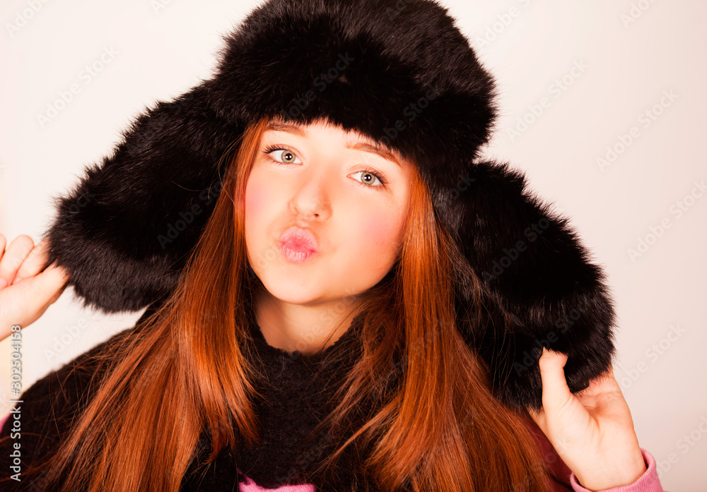 Fashion happy young woman in knitted hat and sweater having fun Fashion happy young woman in knitted hat and sweater having fun
