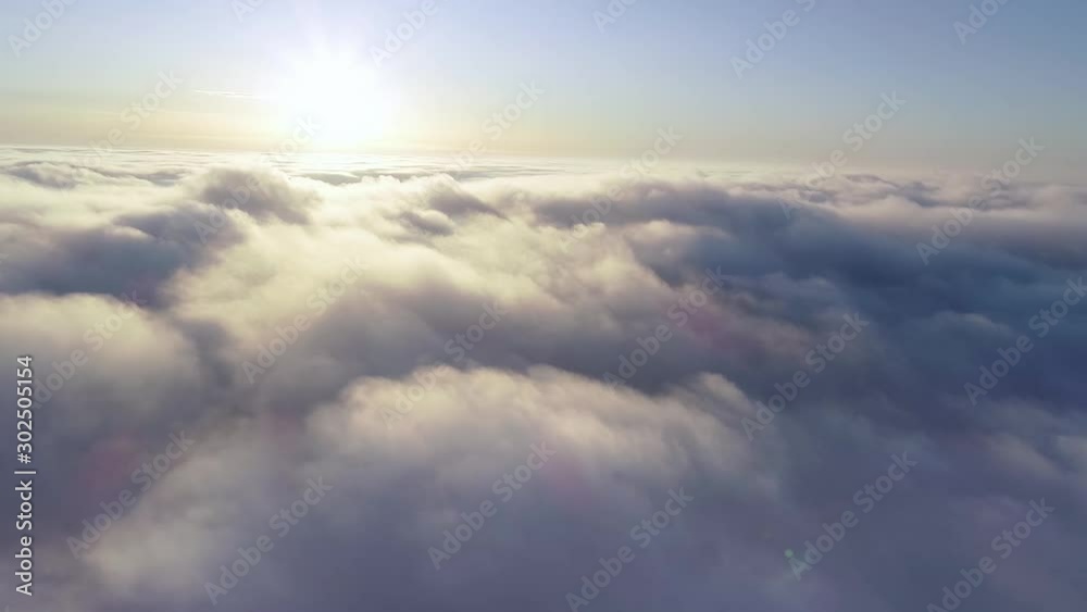 Aerial View. Flying in fog, fly in mist. Aerial camera shot. Flight above the clouds towards the sun. Misty weather, view from above. Aerial View. Flying in fog, fly in mist. Aerial camera shot. Flight above the clouds towards the sun. Misty weather, view from above.