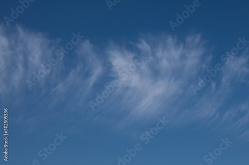 Light cirrus clouds on a background of blue autumn sky  Y