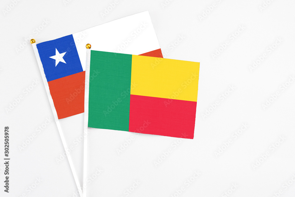 Benin and Chile stick flags on white background. High quality fabric, miniature national flag. Peaceful global concept.White floor for copy space. Benin and Chile stick flags on white background. High quality fabric, miniature national flag. Peaceful global concept.White floor for copy space.