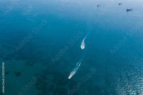 People are playing a jet ski in the sea.Aerial view. Top view.amazing nature background. © Viachaslau