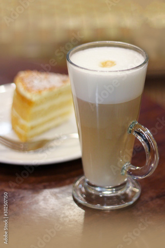 glass mug with cappuccino or latte with empty on a table in a cafe. delicious snack, a leisurely vacation